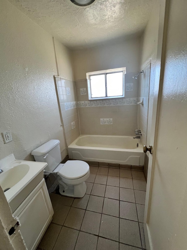 full bathroom with tile patterned flooring, vanity, a textured ceiling, and toilet