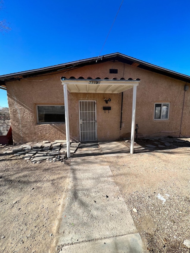 view of exterior entry featuring a patio area