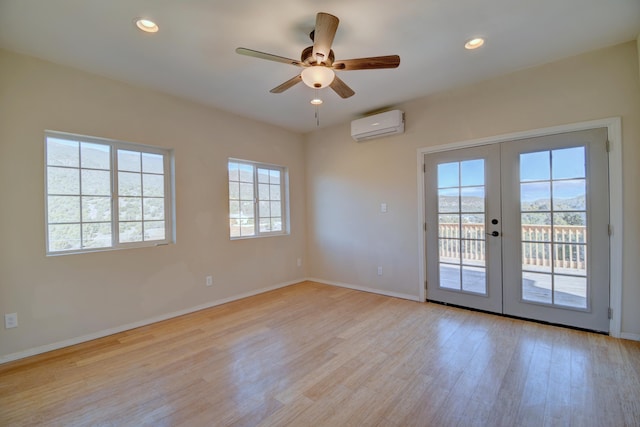 7 Shasta Ct, Cedar Crest, NM 87008 - spare room with a wall unit AC, french doors, ceiling fan, light wood-style flooring, and baseboards