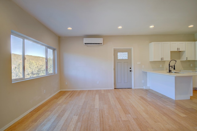 7 Shasta Ct, Cedar Crest, NM 87008 - kitchen with a sink, light countertops, white cabinetry, light wood-type flooring, and a peninsula