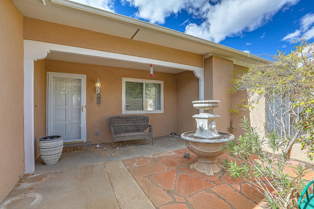 entrance to property with a patio area