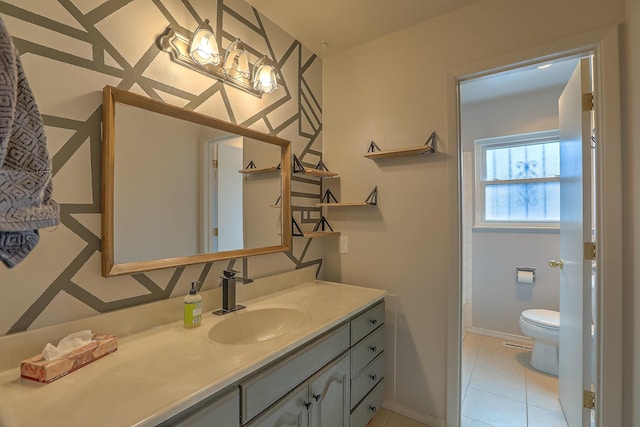 bathroom featuring tile patterned floors, vanity, and toilet