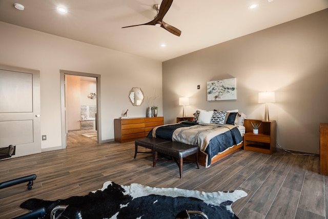 bedroom with connected bathroom, ceiling fan, and dark hardwood / wood-style flooring