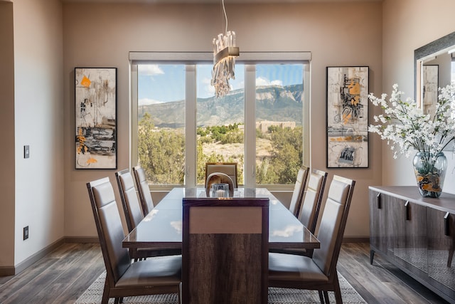 dining space featuring a notable chandelier, a mountain view, and dark hardwood / wood-style flooring