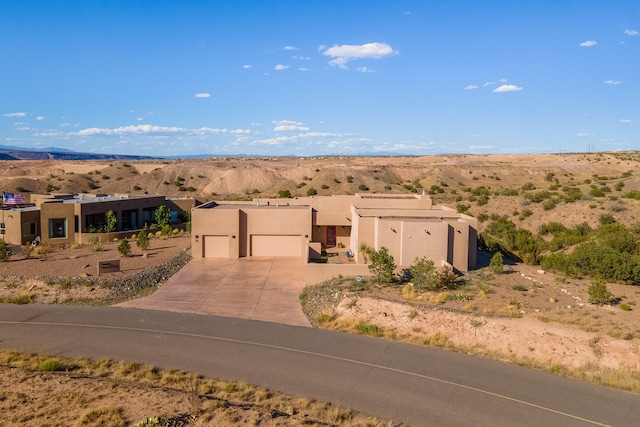 pueblo revival-style home with a garage