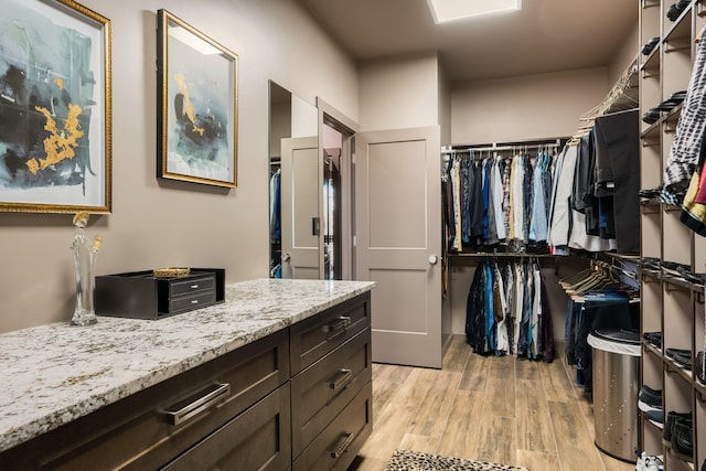 spacious closet with light hardwood / wood-style floors