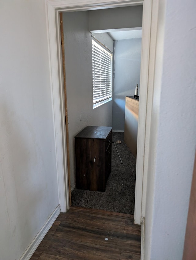 corridor featuring dark hardwood / wood-style flooring