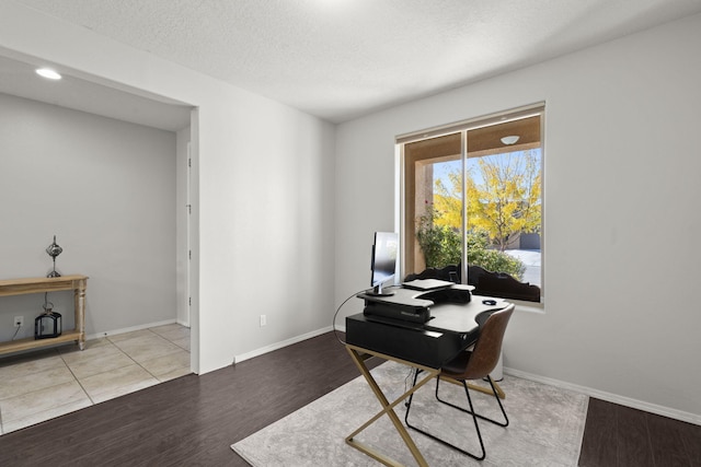 office space with light hardwood / wood-style floors and a textured ceiling