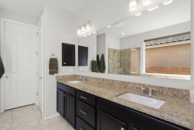 bathroom with vanity, a shower with shower door, and tile patterned flooring