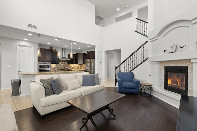 living room with a high ceiling and tile patterned flooring