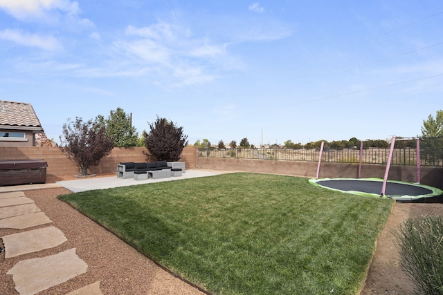 view of yard with a trampoline and a patio area