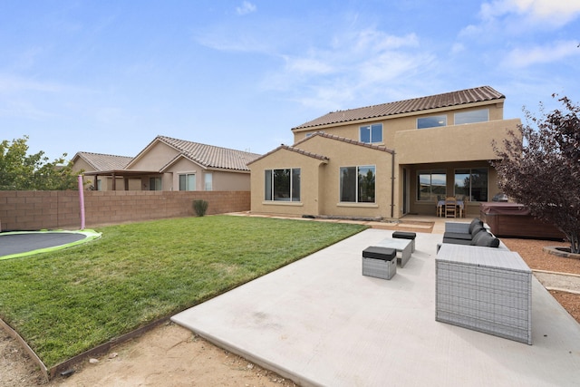 back of property featuring a yard, a patio area, and outdoor lounge area