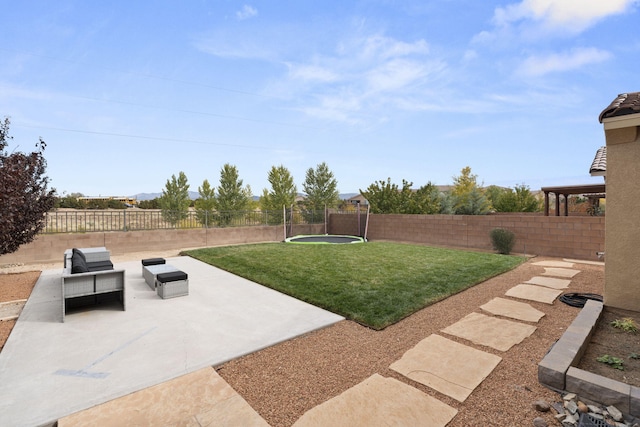 view of yard with a patio and a trampoline