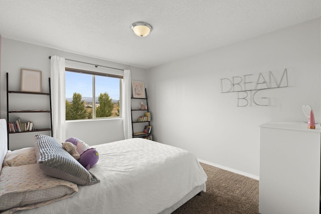 bedroom featuring carpet floors and a textured ceiling