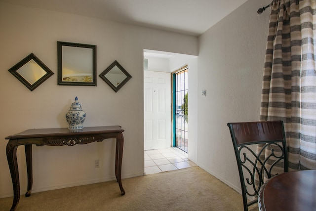 foyer featuring light colored carpet