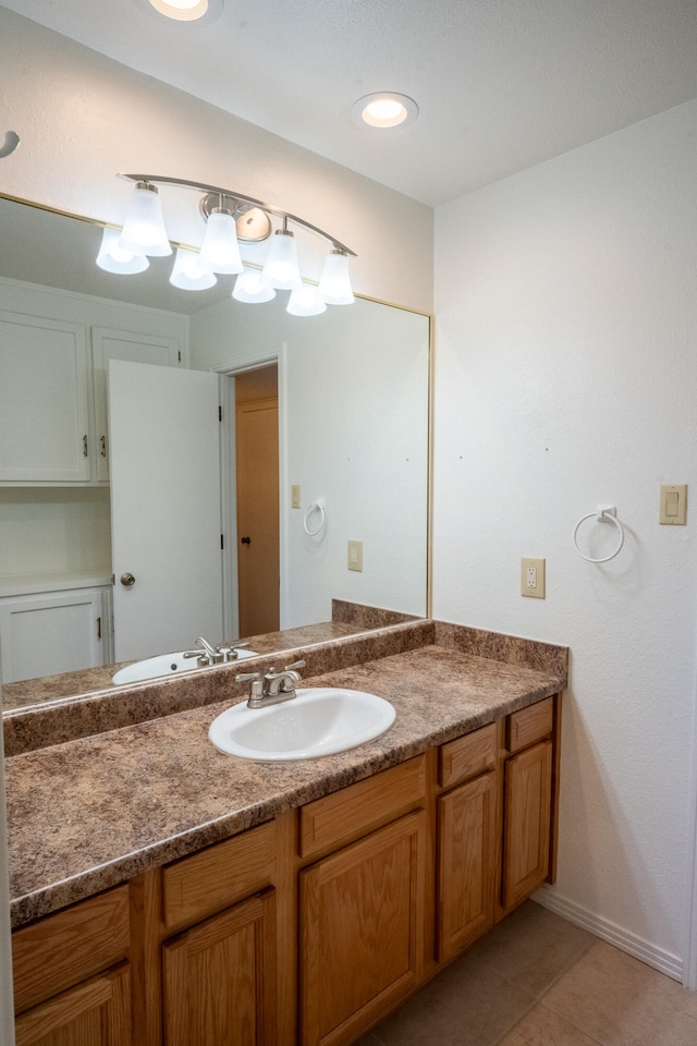 bathroom with tile patterned flooring and vanity