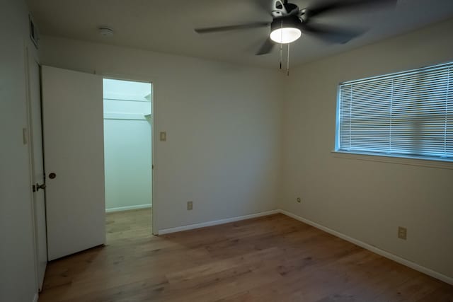 empty room with light hardwood / wood-style floors and ceiling fan