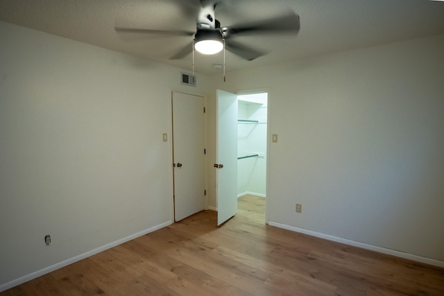 unfurnished room with ceiling fan and light hardwood / wood-style flooring