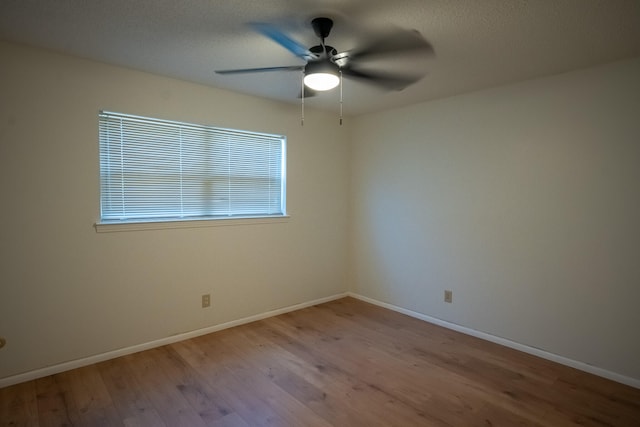 spare room with ceiling fan and light hardwood / wood-style floors