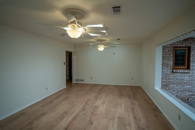 empty room with ceiling fan and light wood-type flooring