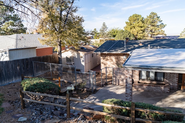 view of yard with a patio area and a storage unit