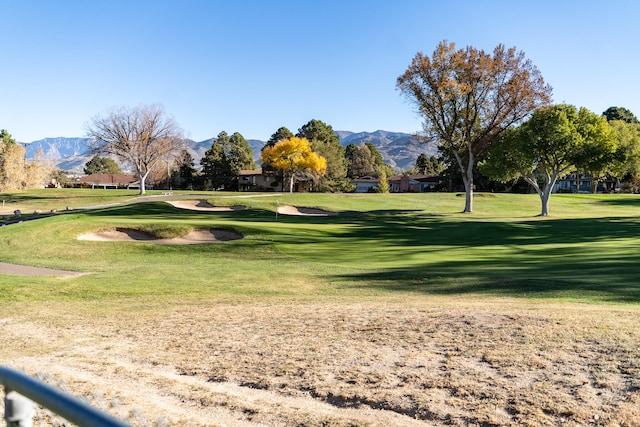 view of home's community featuring a lawn and a mountain view