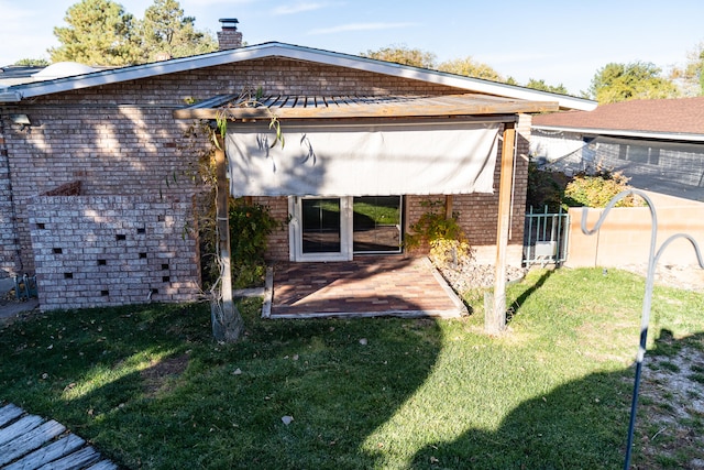 back of house with a lawn and a patio