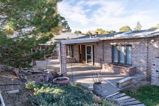 back of property featuring a patio area