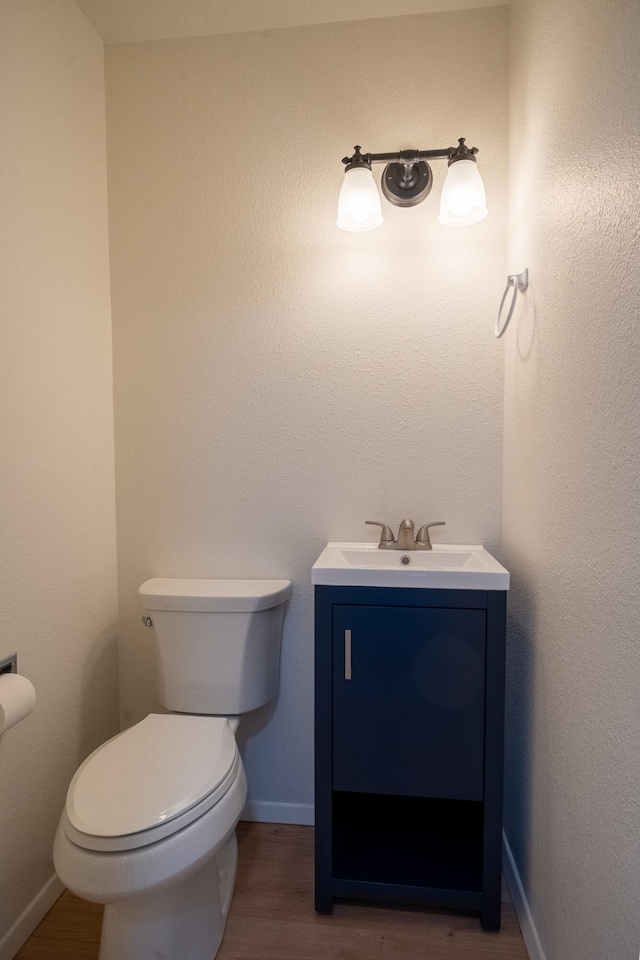 bathroom featuring vanity, toilet, and wood-type flooring