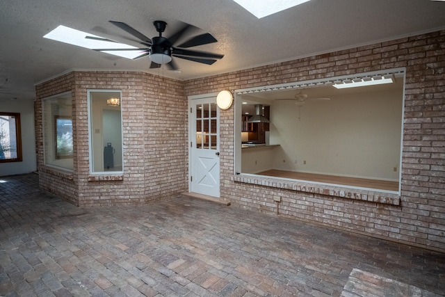 interior space with ceiling fan