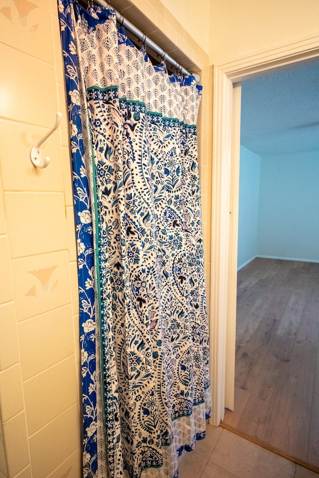 bathroom featuring a textured ceiling and hardwood / wood-style flooring