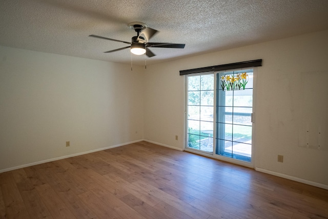 empty room featuring ceiling fan, a textured ceiling, and light hardwood / wood-style flooring