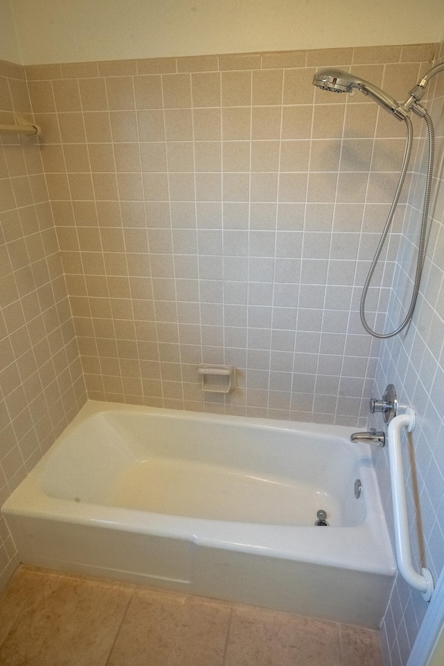 bathroom with tiled shower / bath combo and tile patterned floors