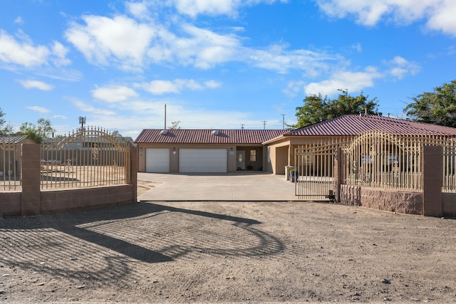 view of front facade featuring fence, an attached garage, stucco siding, concrete driveway, and a tiled roof