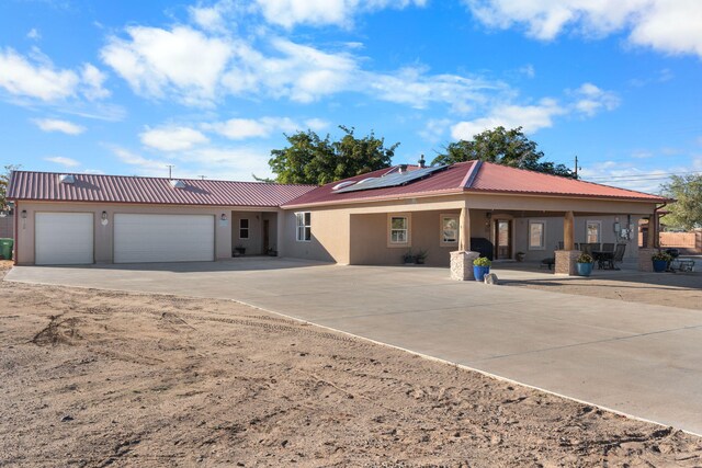 view of front of home with a garage and solar panels