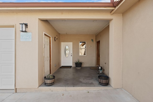 view of exterior entry featuring a garage