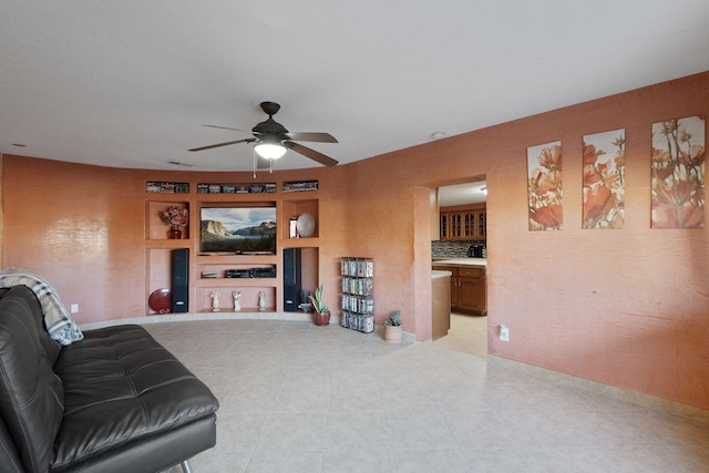 living area featuring light tile patterned flooring, built in features, and ceiling fan