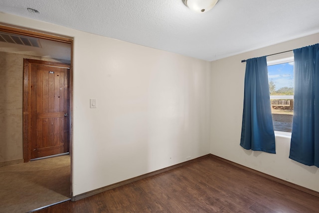 unfurnished room featuring dark hardwood / wood-style flooring