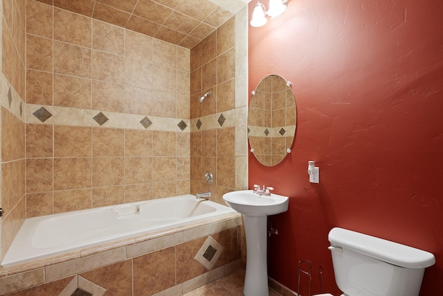 bathroom with tiled tub and toilet