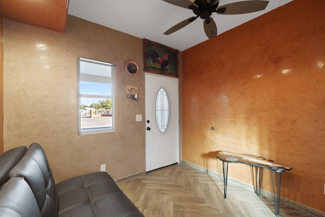 entryway with ceiling fan and light parquet flooring