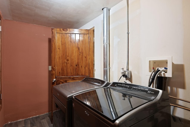 laundry area with dark hardwood / wood-style floors and independent washer and dryer