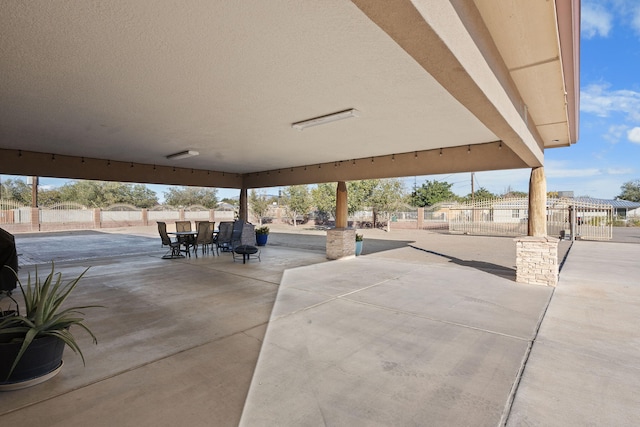 view of patio featuring outdoor dining area and fence