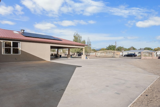view of car parking featuring a gate and fence