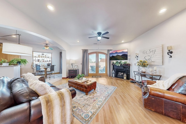 living room with ceiling fan and hardwood / wood-style floors