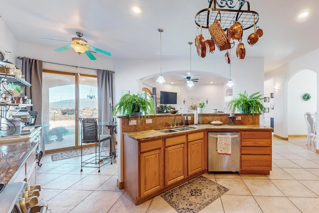 kitchen with sink, light tile patterned floors, dishwasher, and hanging light fixtures