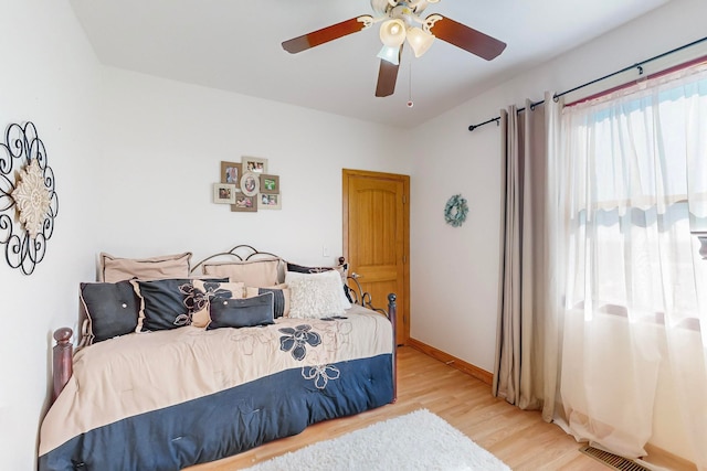 bedroom featuring hardwood / wood-style flooring and ceiling fan