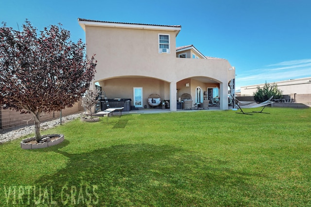 back of property with a patio area and a lawn