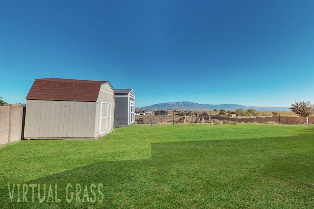 view of yard with a shed and a mountain view