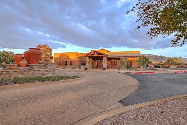 pueblo revival-style home with a mountain view