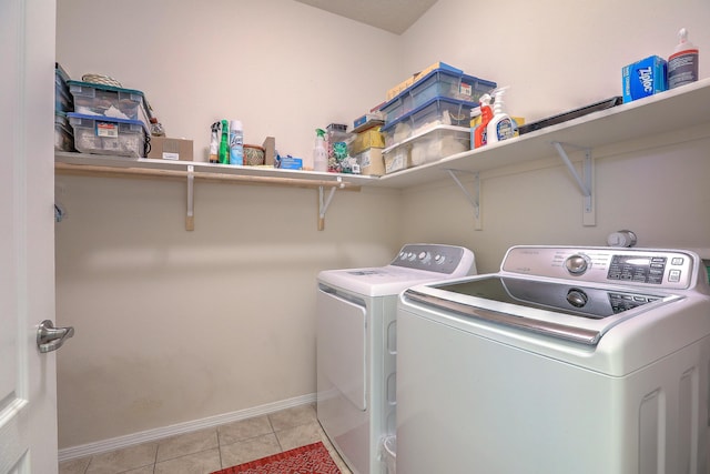 washroom featuring light tile patterned flooring and washer and clothes dryer